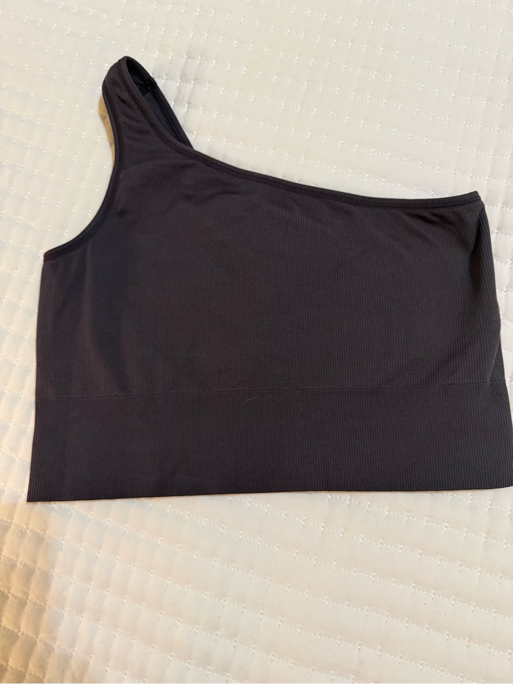black Athleta ribbed one-shoulder crop top.